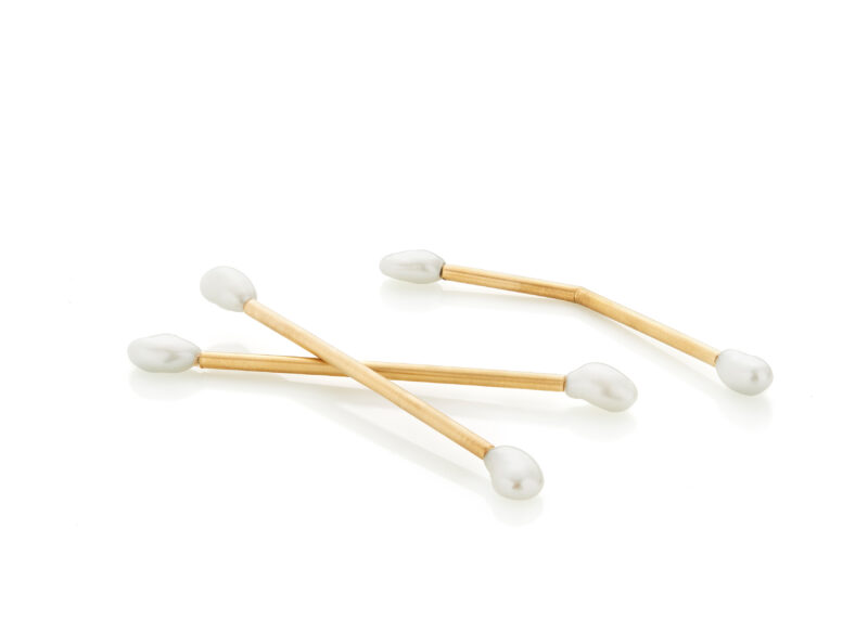 Three cotton swabs with wooden sticks and white tips arranged on a white background.