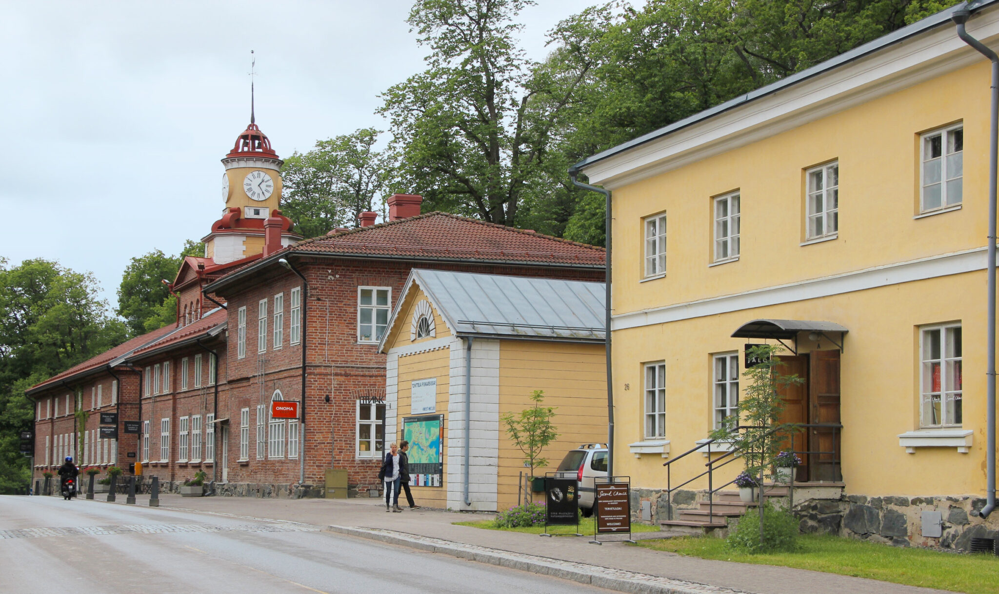 Idyllic village view featuring a church and small wooden houses along a street in Fiskars.