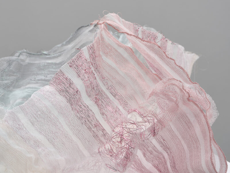 Close-up of layered, textured fabric in soft pink and gray tones from the Mindcraft Project 2022.