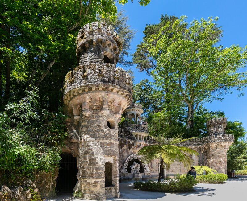 Quinta da Regaleira in Sintra, Portugal, featuring stone towers and lush greenery, captured on May 25, 2019.