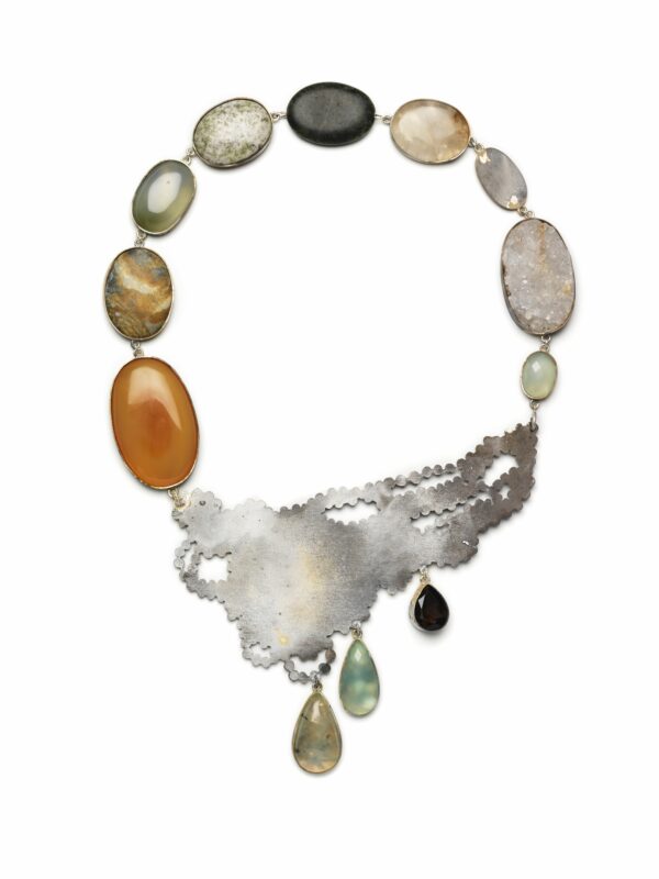 Necklace featuring a silver design with various oval gemstones in shades of orange, green, and gray.
