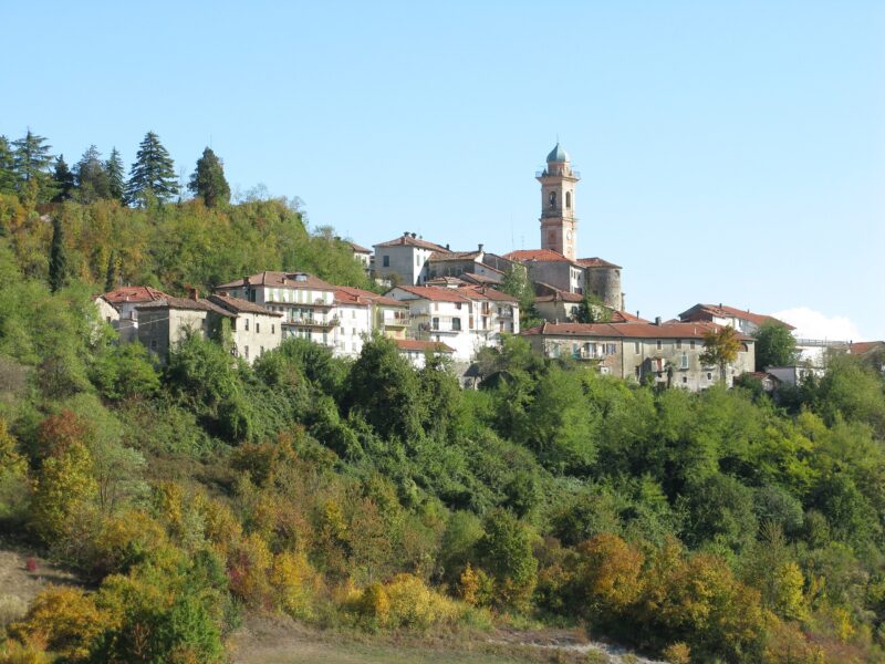 Hilltop village of Pareto in Monferrato, Piemonte, Italy, featuring historic buildings and a clock tower.