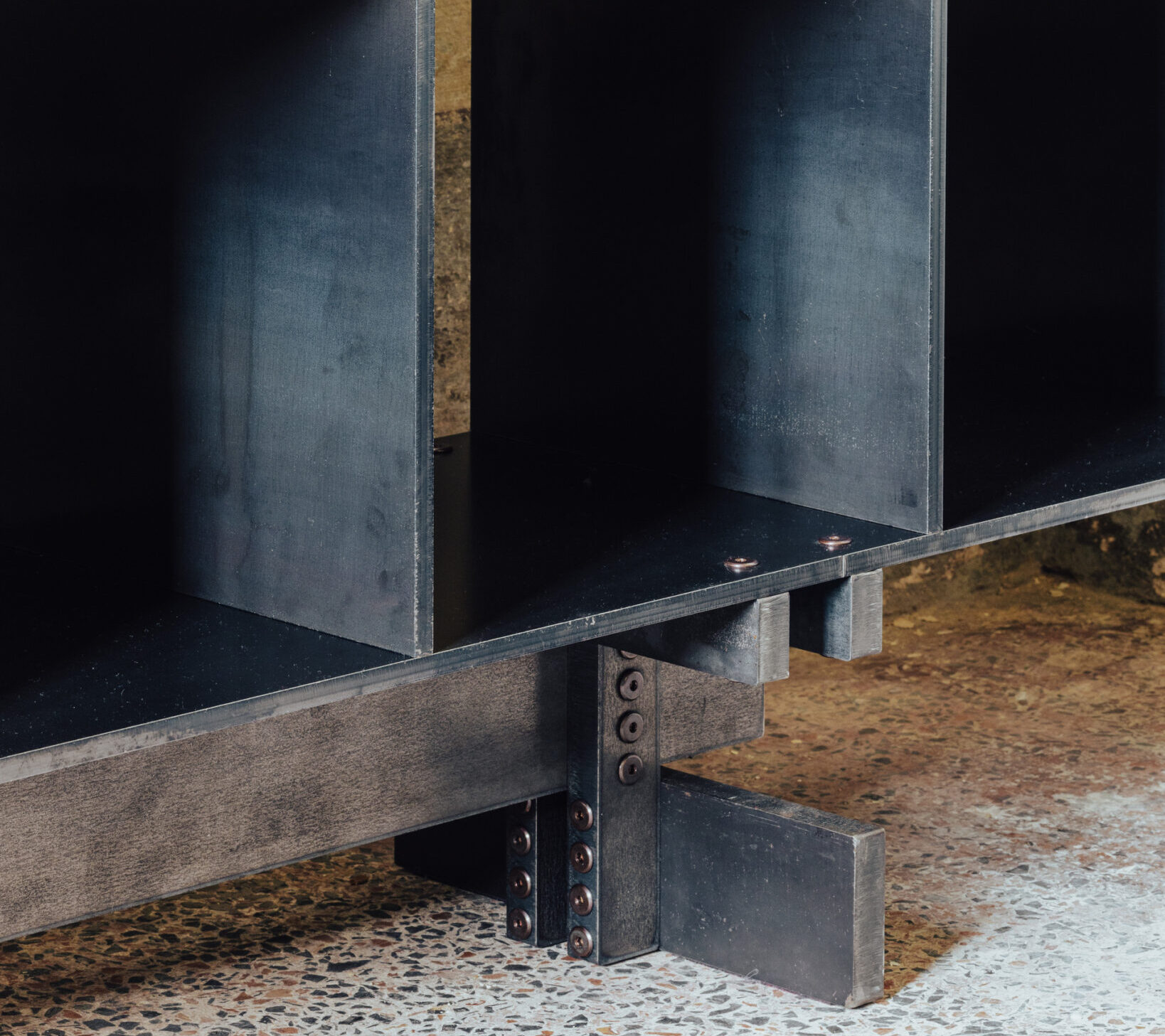 Steel shelving unit with open compartments, showcasing a minimalist design and precise construction.