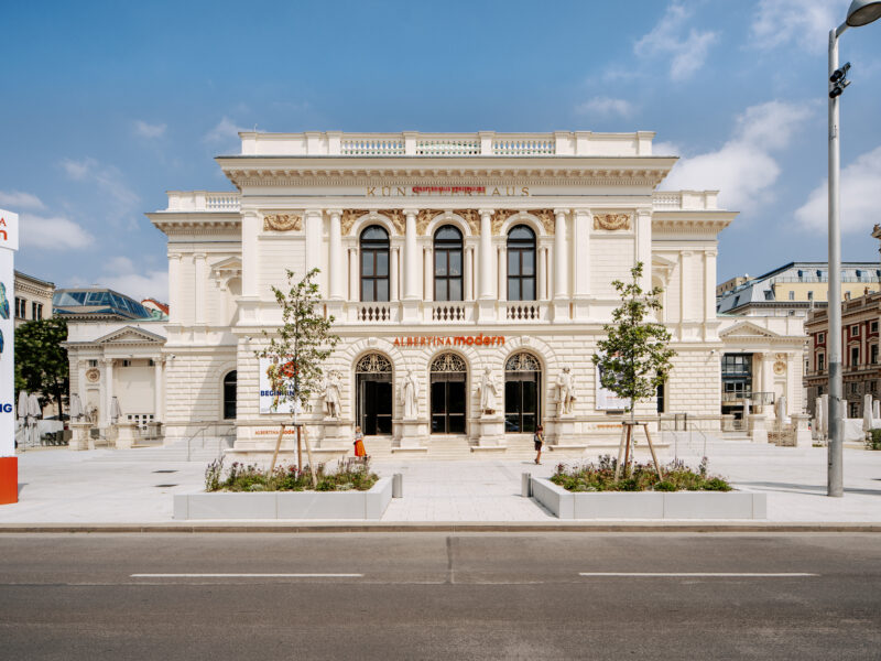 Albertina Modern museum building in Vienna, featuring a classic facade and outdoor landscaping on a sunny day.