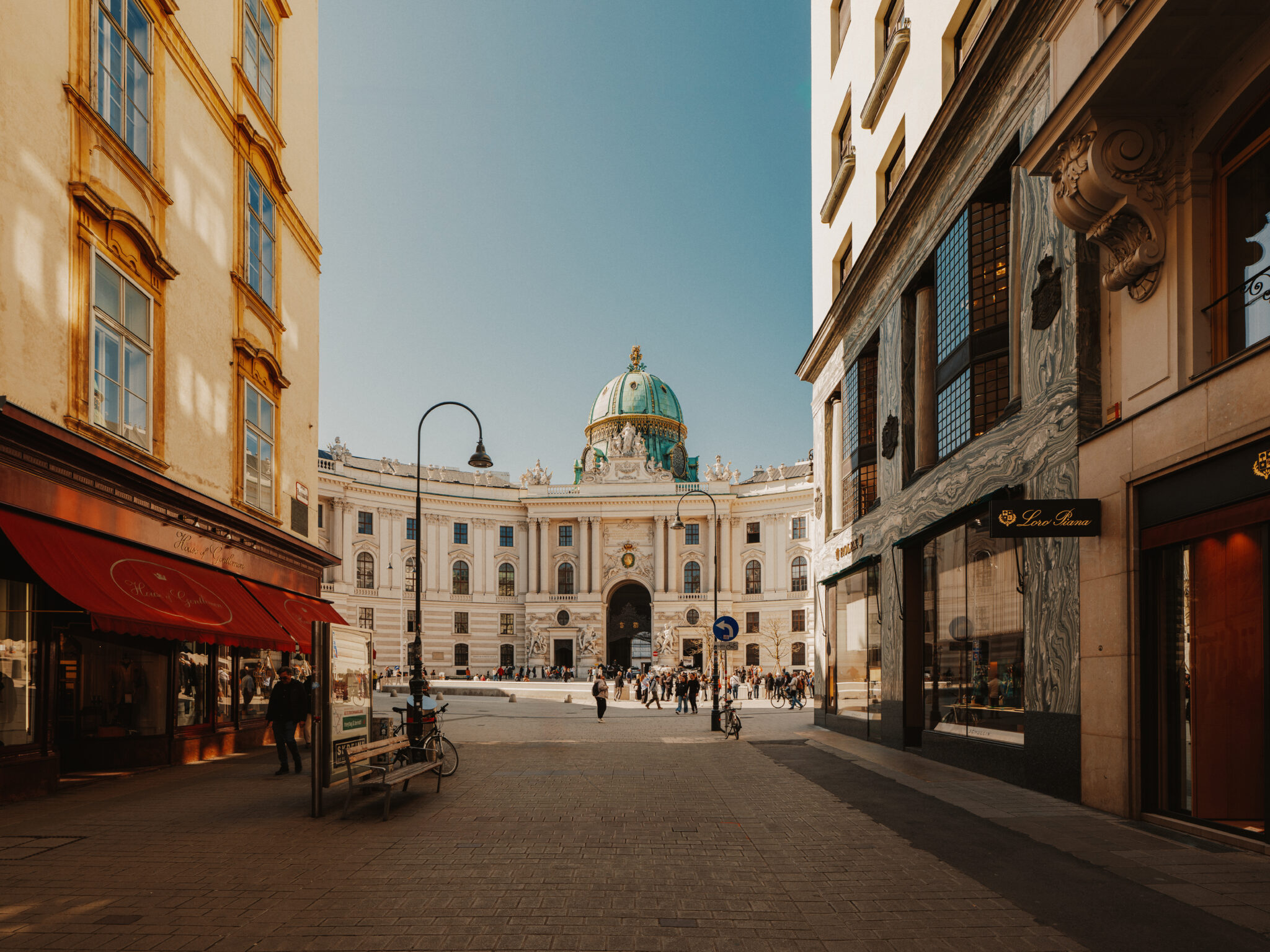 Hofburg Palace at Michaelerplatz, Vienna, showcasing its grand architecture on a sunny spring day.
