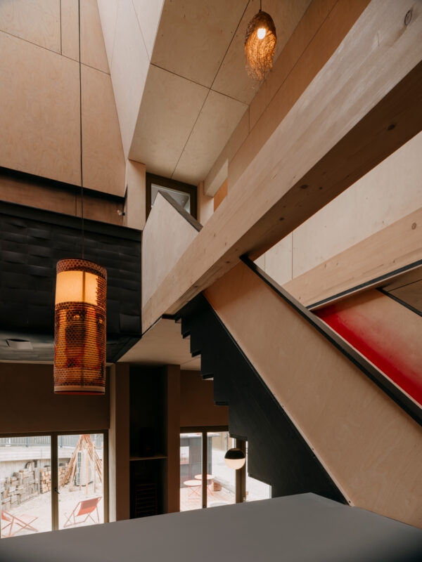 Staircase leading to a roof terrace, with views over a valley, featuring modern lighting and wooden elements.