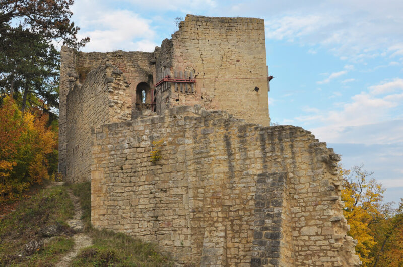 Ruins of Lobdeburg near Jena, featuring stone walls and remnants of a tower against a cloudy sky.