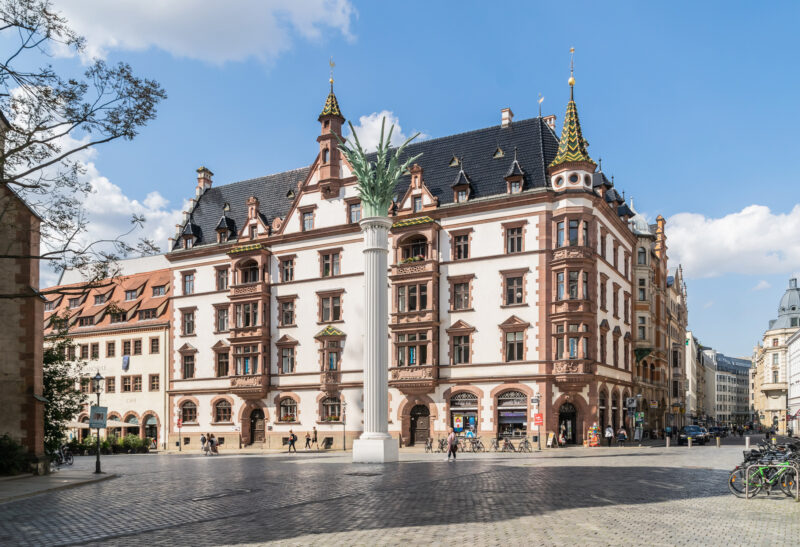Historic Predigerhaus in Leipzig, featuring ornate architecture and a tall column in the foreground.