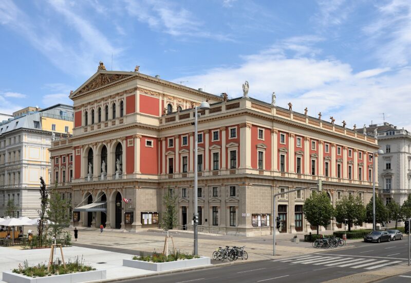 Historic building of the Wiener Musikverein in Vienna, featuring ornate architecture and a clear blue sky.