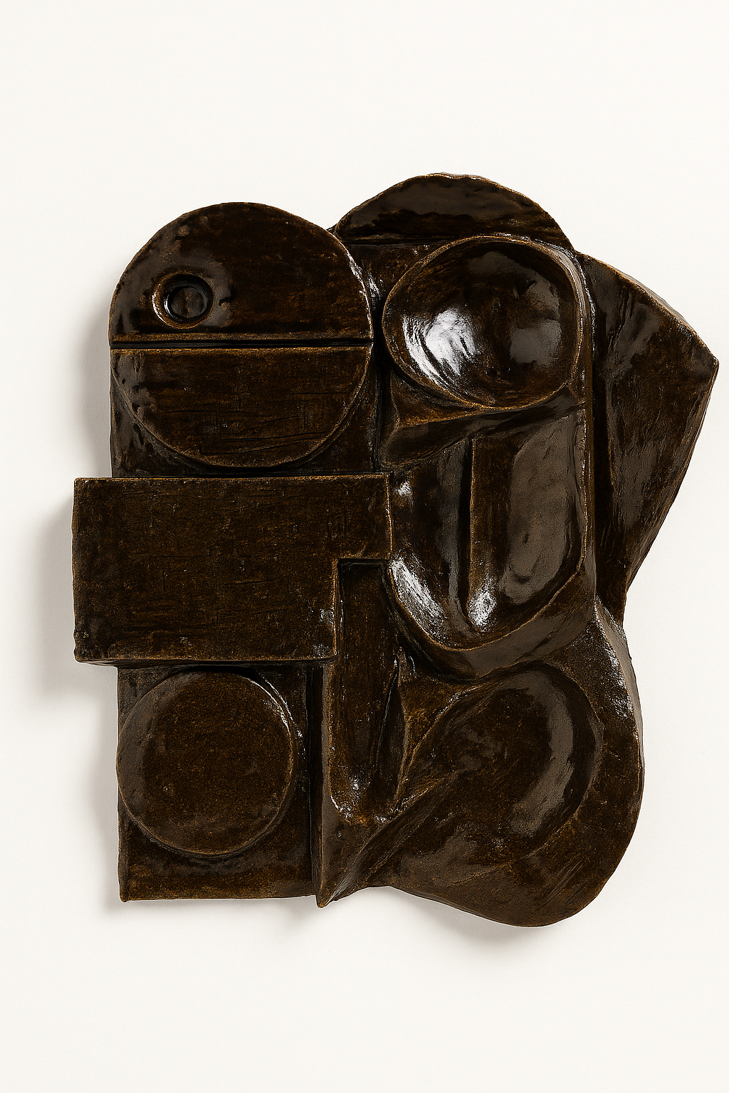 Abstract sculpture with geometric shapes and smooth surfaces, predominantly dark brown in color.