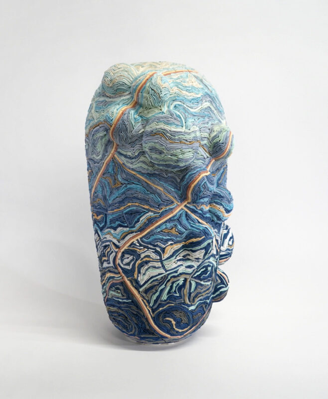 Coloured porcelain sculpture titled "Linn Ribbons" by Alice Walton, featuring intricate blue and green patterns.