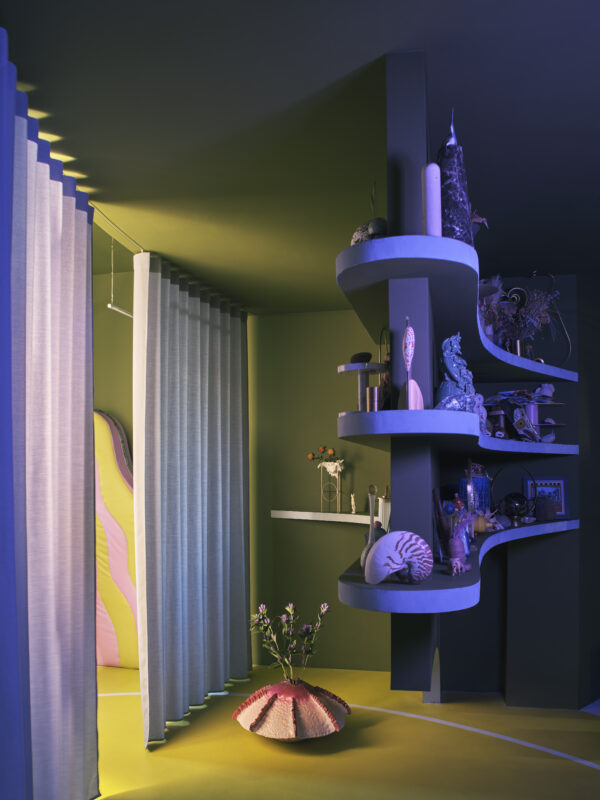 Colorful interior space featuring curved shelves with sculptures, a flower vase, and soft curtains, illuminated in purple ...