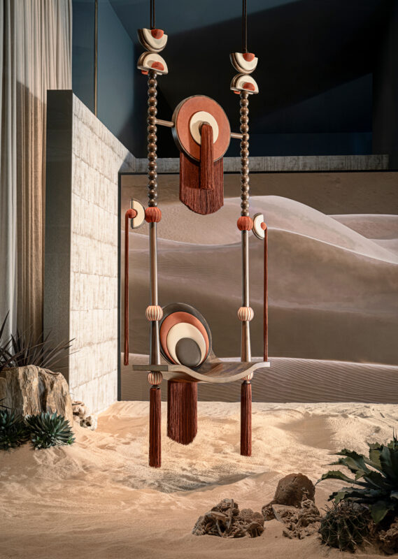 A stylized swinging throne with vibrant colors and textures, set against a sandy, desert-like backdrop.