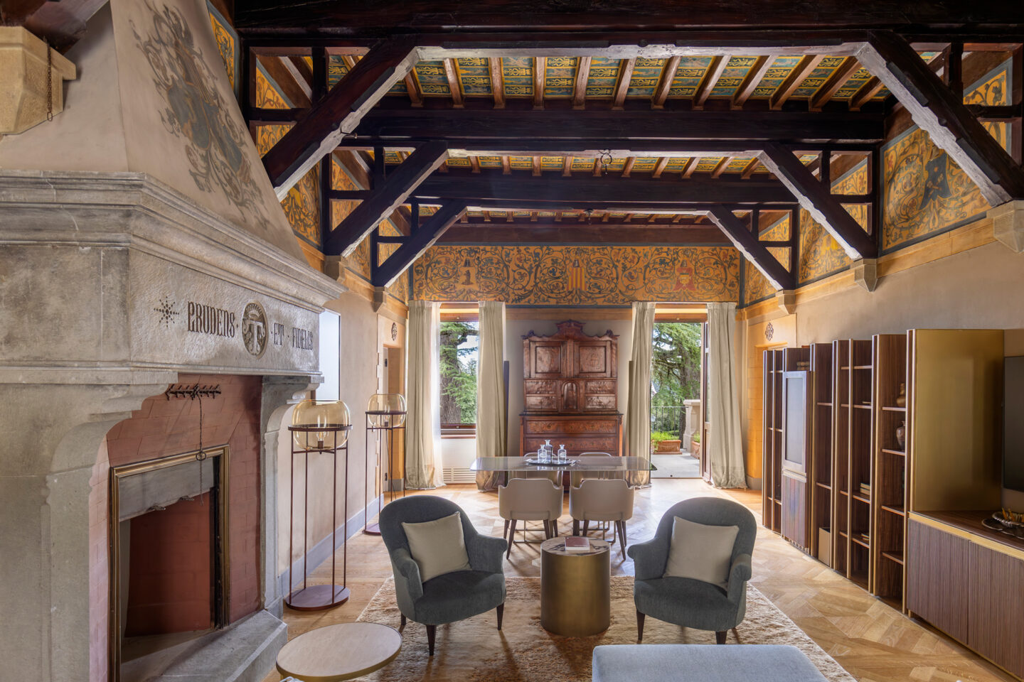 Luxurious living room in Borgo Dei Conti Resort, featuring ornate ceiling, elegant furniture, and scenic views.