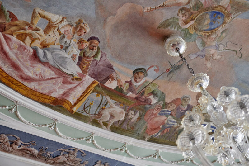 Ceiling fresco in Palazzo Garzoni, featuring ornate figures and a chandelier, by Colin Dutton.