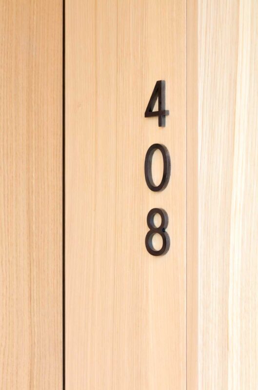 Room number 408 displayed in black on a light wooden door.