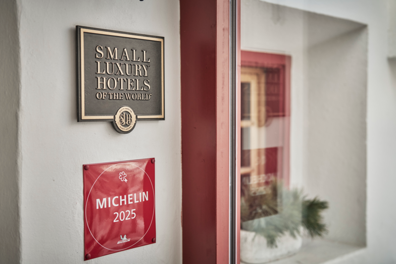 Signage for "Small Luxury Hotels of the World" and a "Michelin 2025" plaque at Goldene Rose Karthaus.