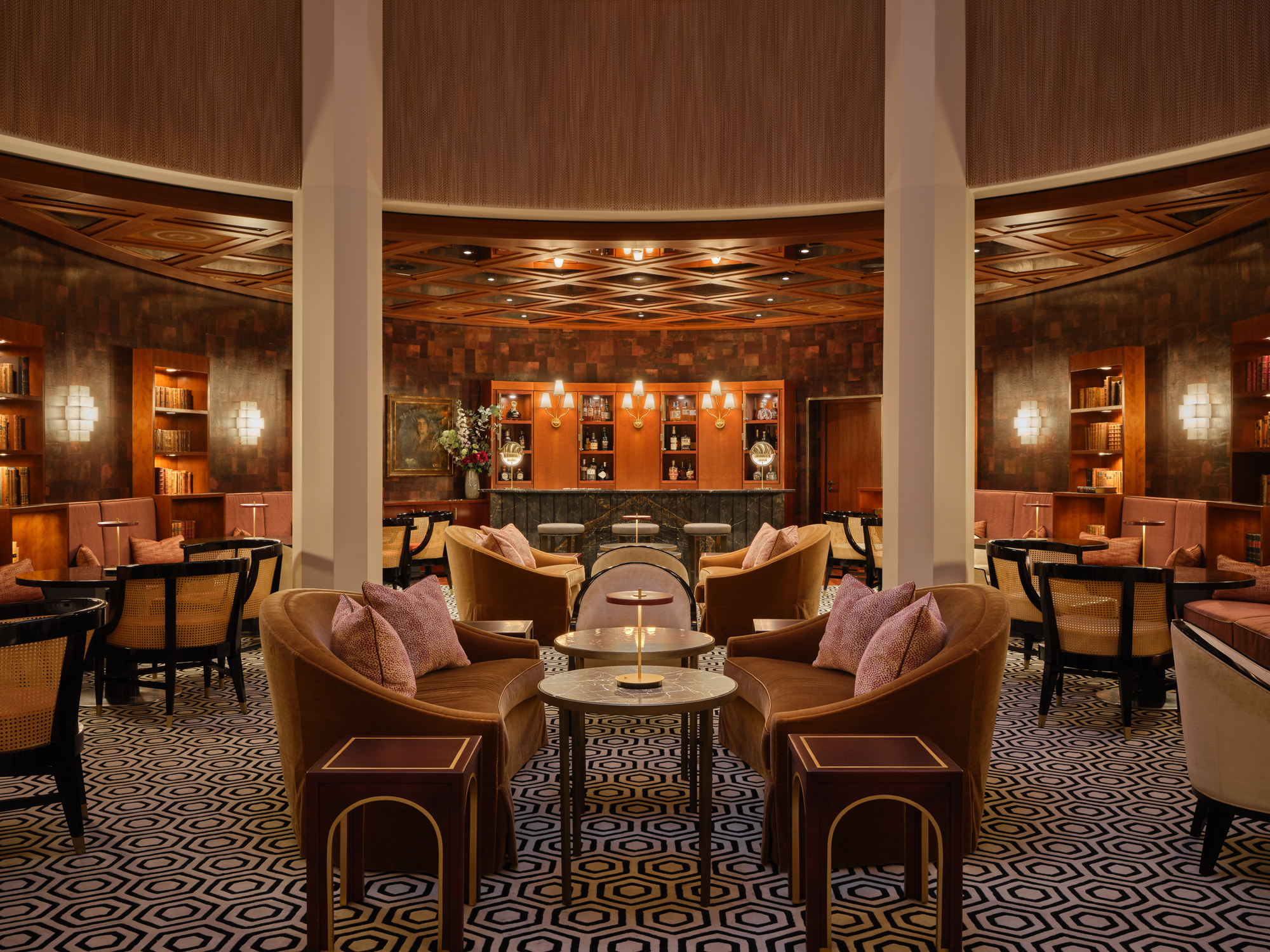 Elegant lounge area of Circle Bar at The Charles Hotel, featuring plush seating and a stylish patterned floor.