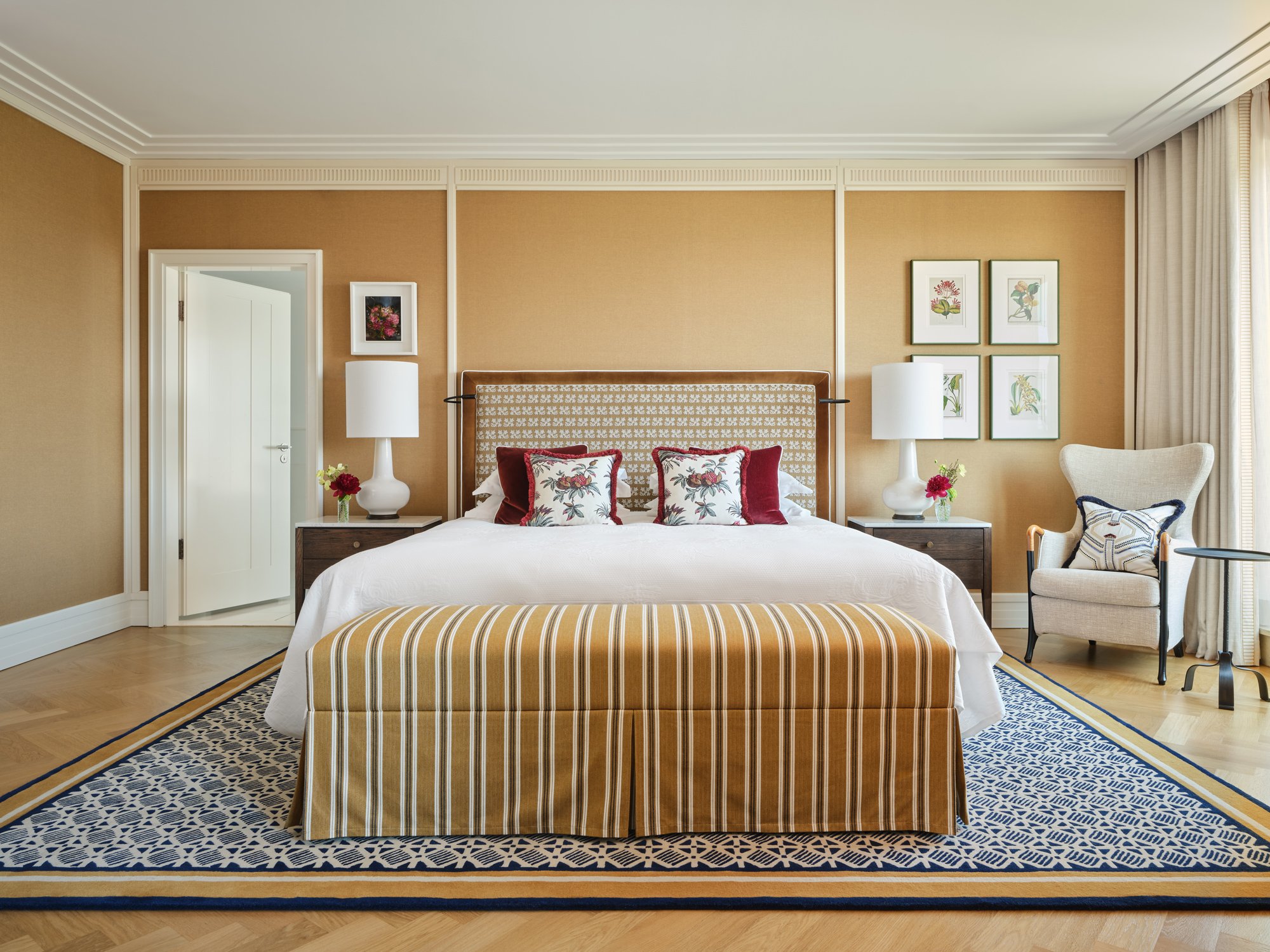 Monforte Suite bedroom at The Charles Hotel, featuring a king bed, decorative pillows, and elegant furnishings.