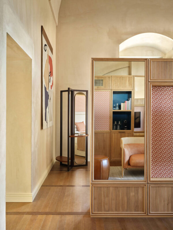 Stylish corner junior suite with sea view, featuring wooden accents, a cozy seating area, and modern decor.