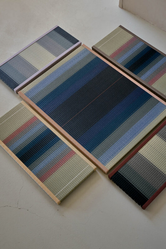 Colorful tatami mats arranged in a geometric pattern on a light-colored floor.