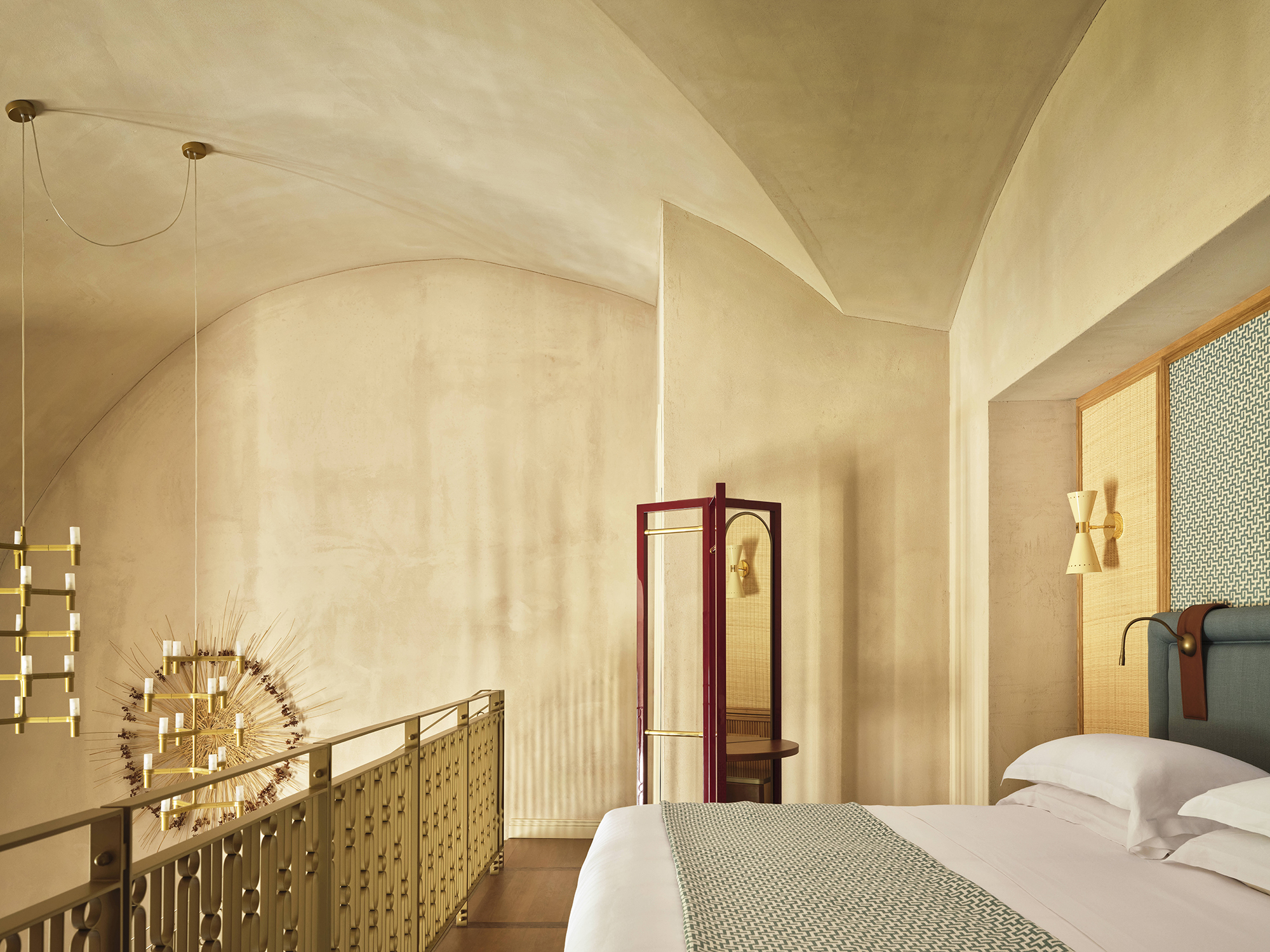 Elegant duplex suite with a minimalist design, featuring a curved ceiling, warm tones, and stylish decor elements.