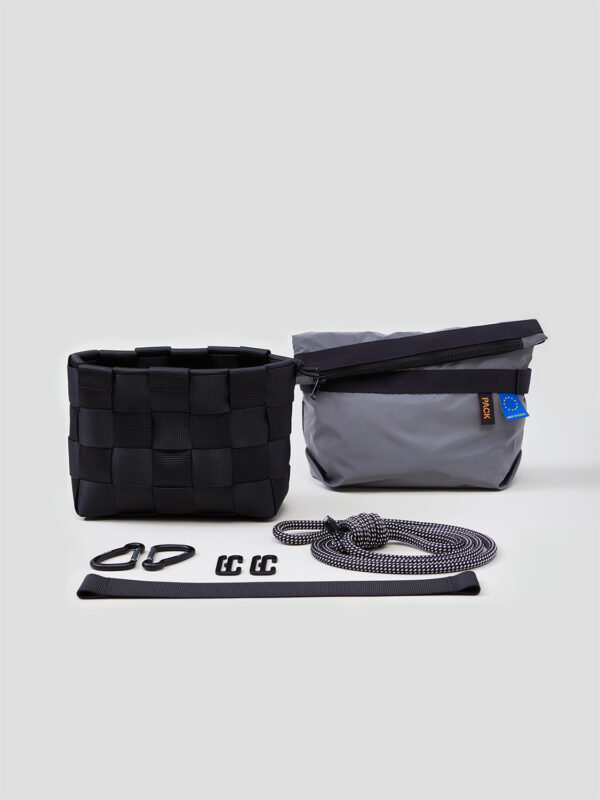 Modular weaving system featuring a black woven basket, a gray pouch, and accessories including carabiners and straps.
