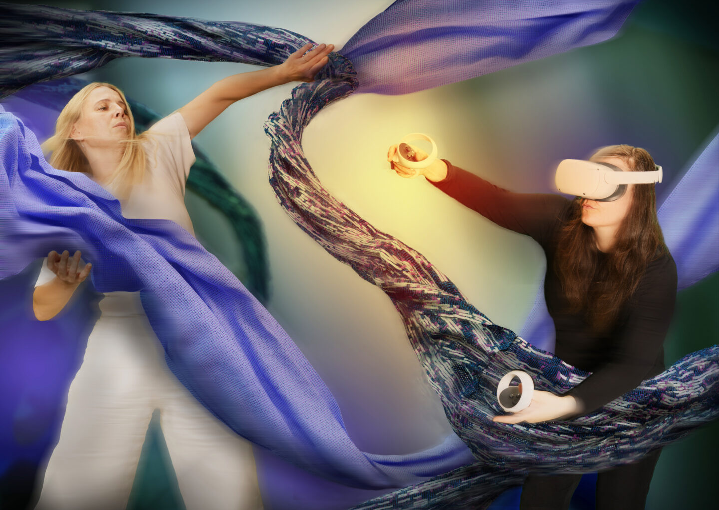 Two women interact with flowing blue fabric in a virtual reality setting, one wearing a VR headset and holding controllers.