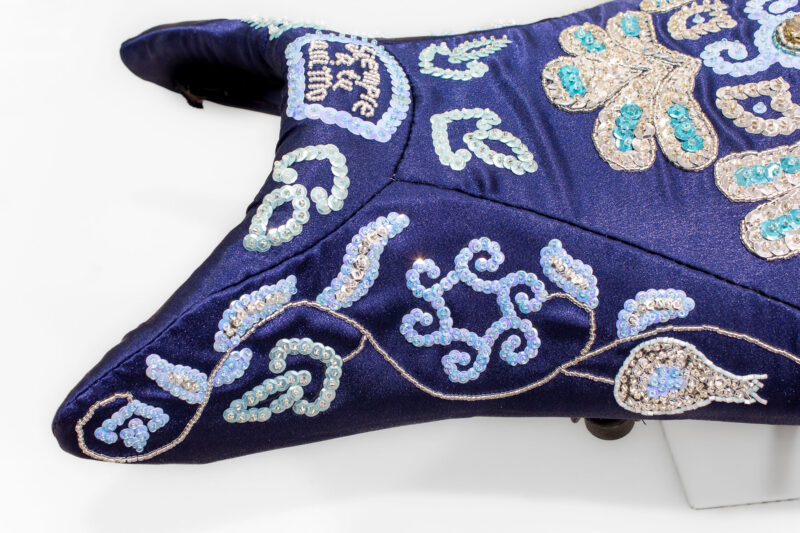 Embellished fabric in shades of blue with intricate beadwork and floral patterns, part of Jorge Mañes Rubio's artwork.