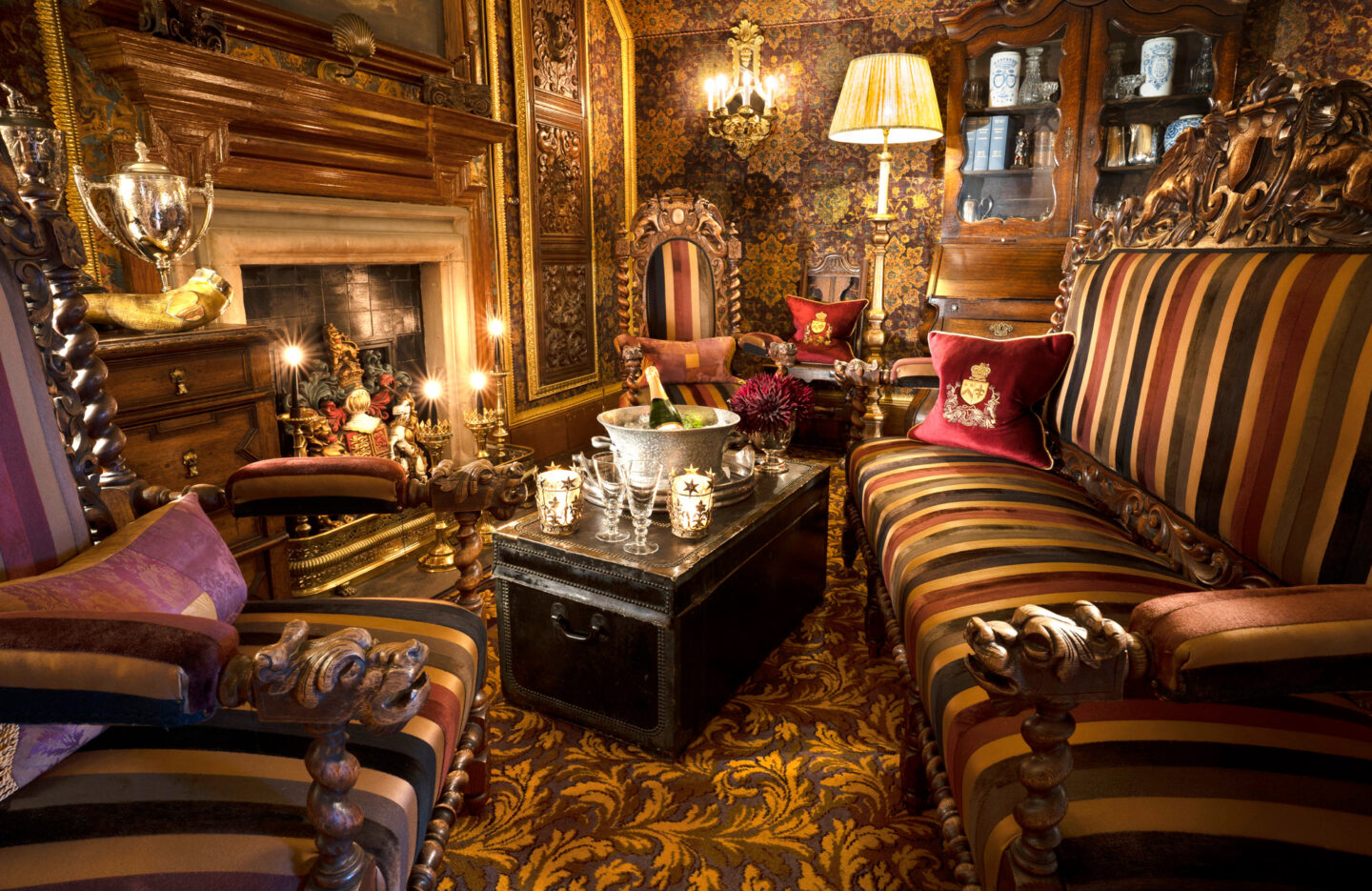 Luxurious sitting area in Prestonfield House with ornate furniture, rich patterns, and a fireplace, creating an elegant am...