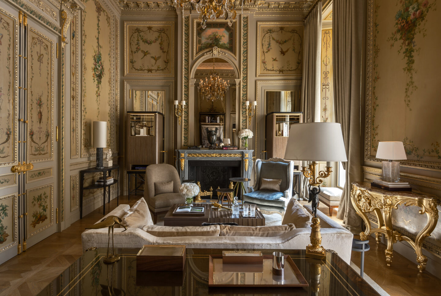 Luxurious living room in Hôtel de Crillon, featuring ornate decor, elegant furniture, and a chandelier.