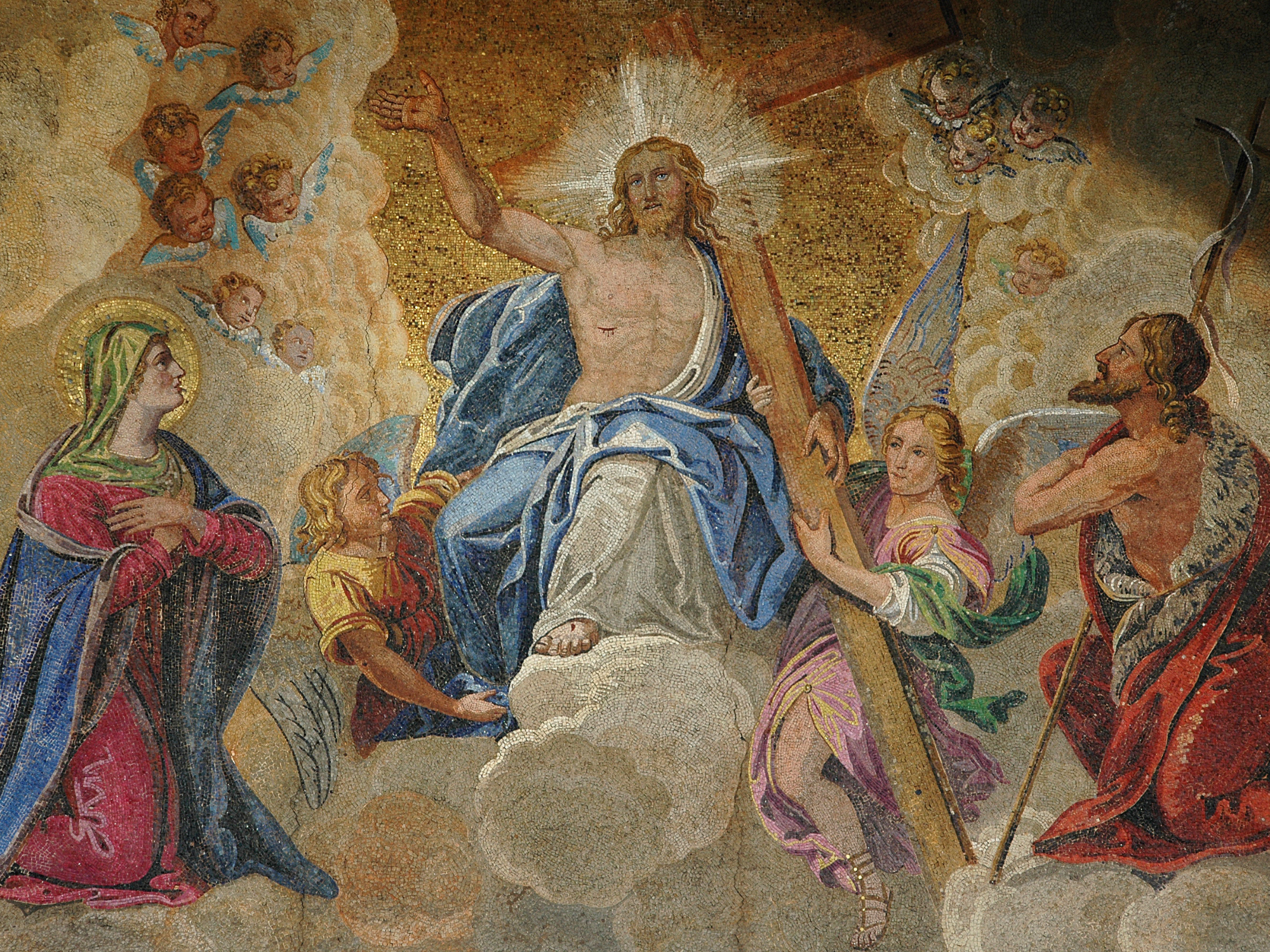 Christ seated in glory on clouds, flanked by angels and figures, with a radiant halo and holding a staff.