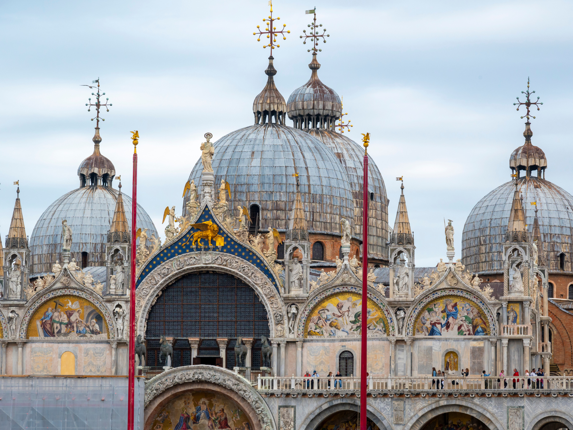 St. Mark's Basilica in Venice, featuring ornate domes and intricate façade details.