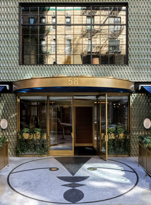 Facade of The Manner building featuring a geometric design, large entrance, and reflective windows at 58.