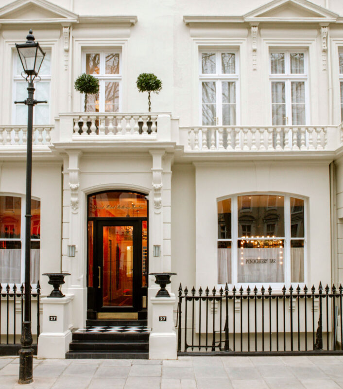 Elegant facade of Grand Hotel Bellevue featuring large windows, decorative elements, and a welcoming entrance.